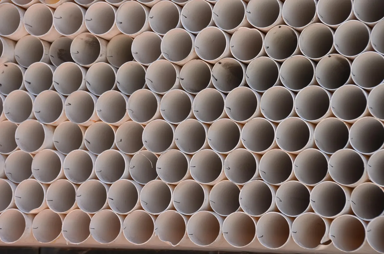Stacked white PVC pipes ready for a sewer line job