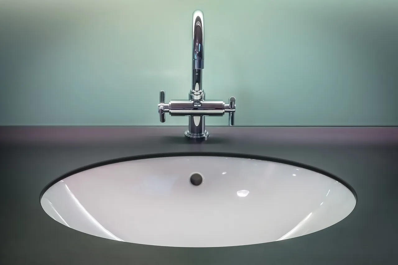 Chrome faucet with separate hot and cold handles over a bathroom sink